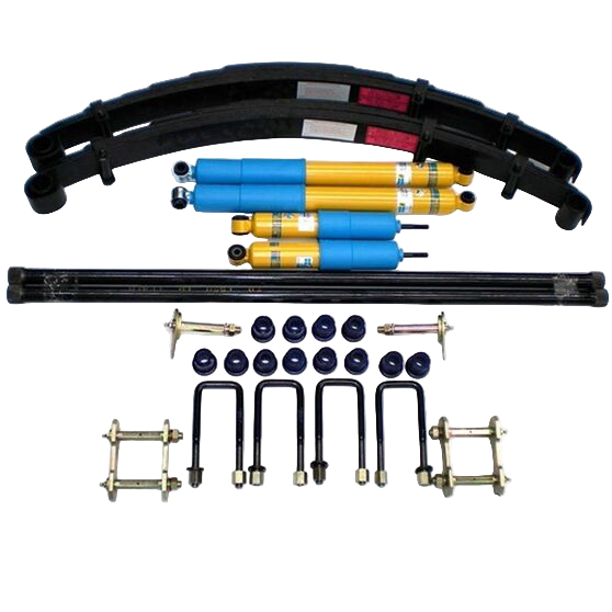 An assortment of vehicle lift kit components including shocks, torsion bars, leaf springs, and mounting hardware spread out on a white background.